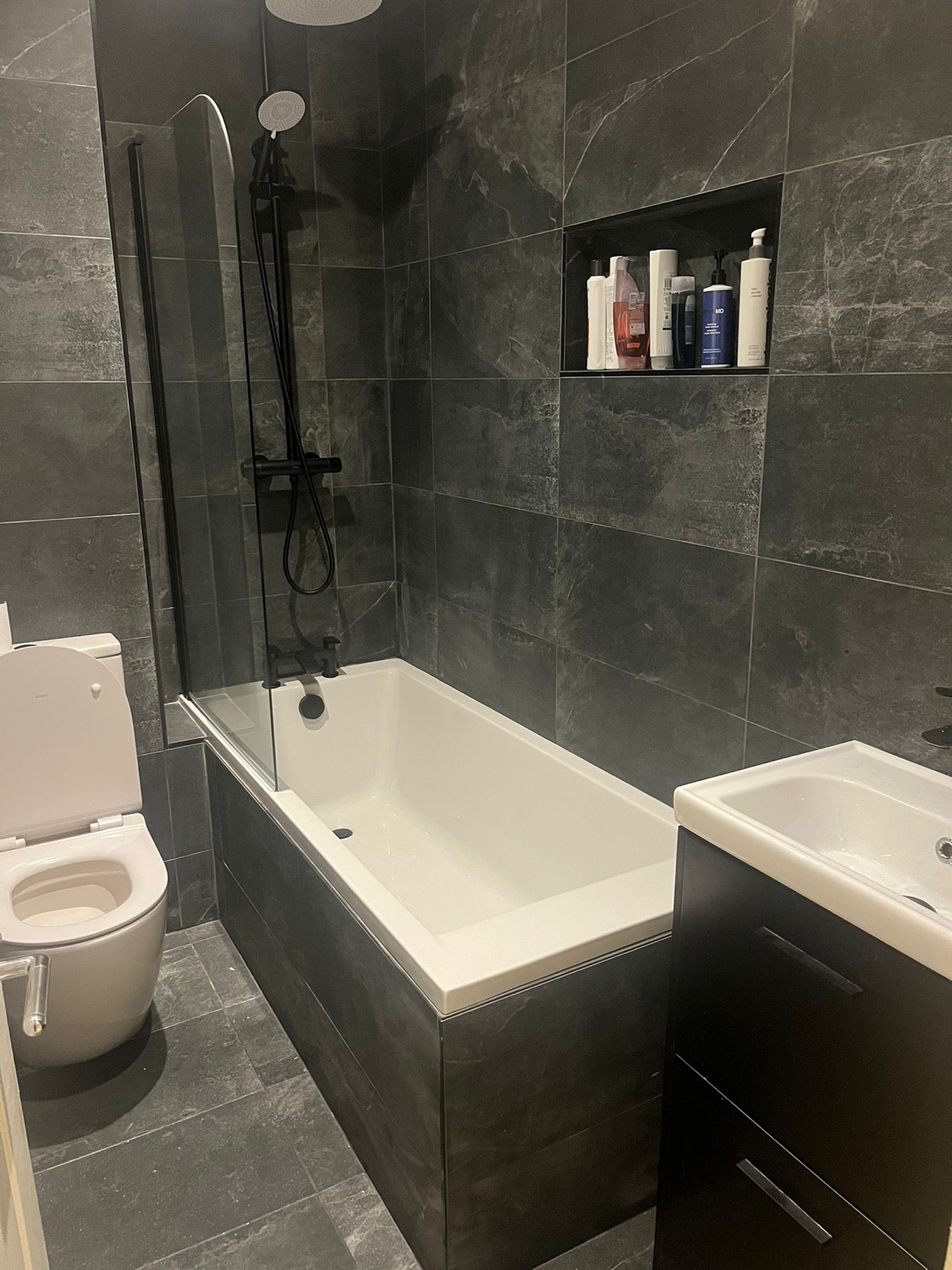 Renovated main bathroom with large-format grey slate-effect tiling in Blackrock, Dublin by Foxstone Construction