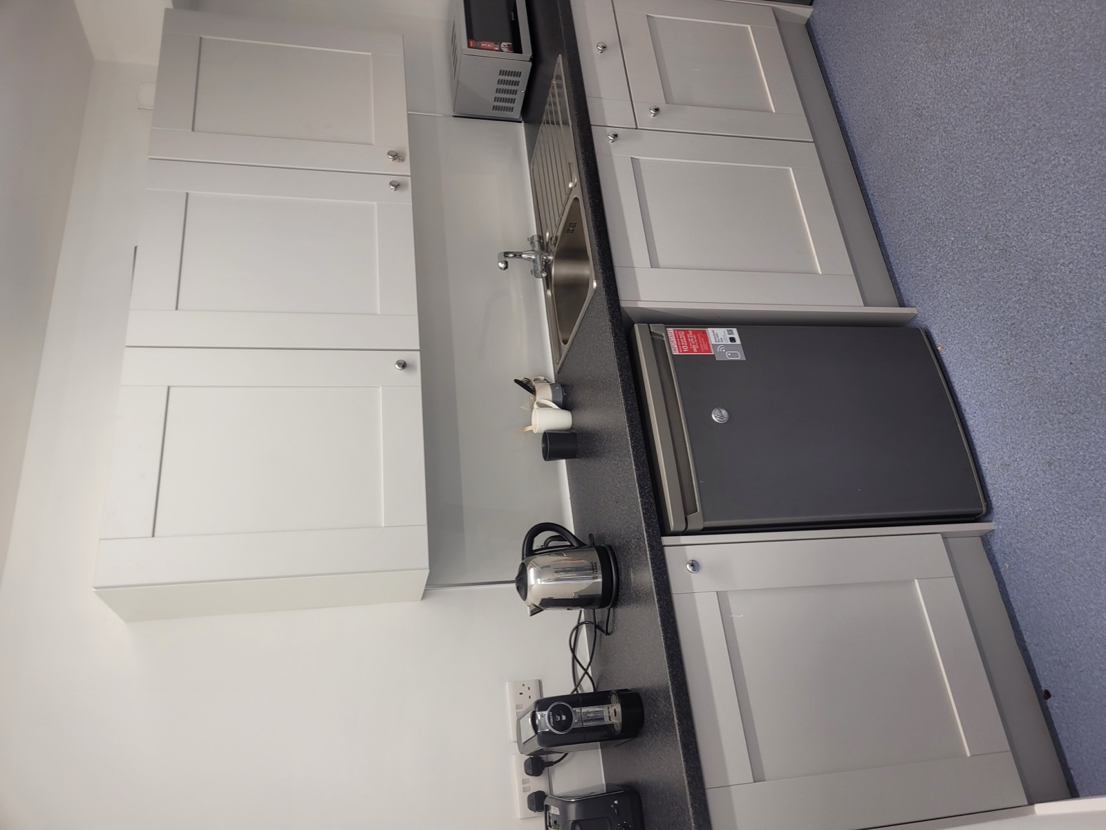 Fitted kitchenette with sink and appliances built for a security operations team in Dublin by Foxstone Construction